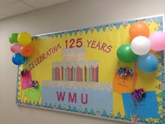 a bulletin board with balloons, streamers and confetti for celebrating fifteen years