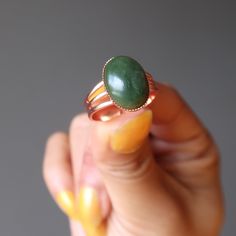 Wear this Nephrite Jade ring and bask in the riches of the world. Choose Jade when you want to attract a flurry of abundance. The shiny copper setting gets you noticed by the right crowd. This lucky green Jade gemstone ring is all about the good things in life.  Positive Affirmation: "I am ready for a flurry of abundance" Intentions: Abundance Stone, Love Crystal Primary Chakra: Heart Chakra STYLE DESCRIPTION Your new ring features a natural Nephrite Jade. This is a dark green stone that may sho Good Things In Life, Jade Gemstone, Lucky Green, Nephrite Jade, Jade Ring, Copper Rings, Positive Affirmation, Brass Ring, Green Gemstones