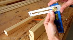 a person is measuring wood with a ruler