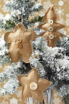 three christmas ornaments hanging from a tree in front of a gold and white wallpaper