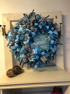 a blue and white wreath with the words home sweet home