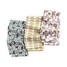 three napkins with different patterns on them