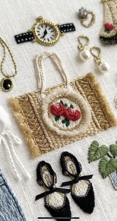 various embroidered items are displayed on a table