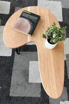 a coffee table with a book on it and a potted plant