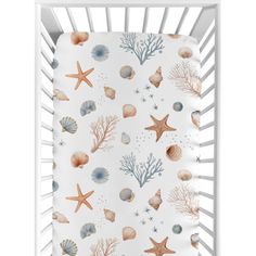 a crib sheet with shells and starfishs on it