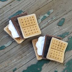 two pieces of cloth and some crackers on a wooden surface