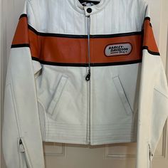 Women’s Harley Davidson Leather Jacket Size Small. Heavy Weight Leather. Beautiful Sporty Jacket. Never Worn. Orange Color Polyester Inner Lining. Two Zipper Hand Warming Pockets, Zipper Sleeve Ends, Snap-Down Collar, Two Inside Pockets, Elastic Sides. Casual White Leather Winter Jacket, Casual White Leather Jacket For Winter, Casual White Biker Jacket For Fall, Classic White Leather Jacket, Classic Fitted White Leather Jacket, White Leather Winter Outerwear, Classic White Leather Jacket With Long Sleeves, White Fitted Leather Outerwear, Fitted White Leather Outerwear