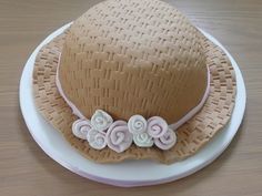 a brown hat with white flowers on it