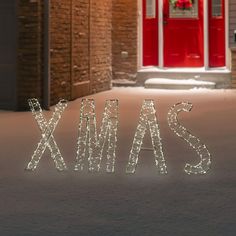 the word xmas spelled out in front of a red door