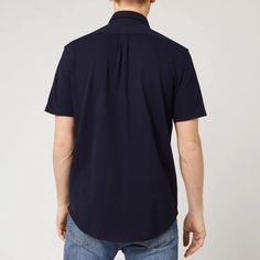 This navy short-sleeved shirt by Polo Ralph Lauren is detailed with a buttoned collar and a central placket with contrasting white buttons. The forever investment is completed with an embroidered polo player logo on the chest. Navy Polo Shirt With Button Closure For Work, Poplin Collared Shirt With Button Closure, Poplin Collared Shirt, Navy Cotton Polo Shirt With Button Closure, Navy Short Sleeve Polo Shirt For Work, Formal Short Sleeve Cotton Polo Shirt, Navy Polo Collar Shirt For Work, Short Sleeve Polo Shirt For Business Casual, Navy Collared Shirt With Buttons