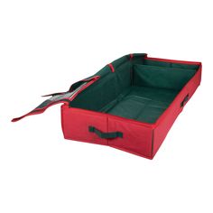 a red and green storage box with scissors in the bottom section on a white background