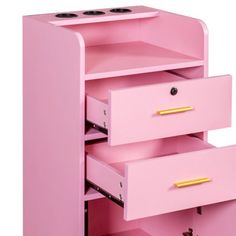 a pink dresser with three drawers and gold handles on the bottom drawer is open to show its contents