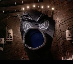 an overhead view of a blue trash can in a room with halloween decorations on the walls