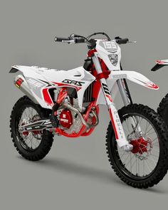 a white and red dirt bike on a gray background