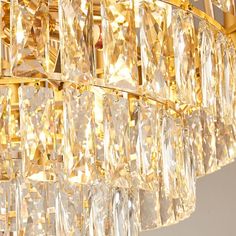 a golden chandelier with many crystal pieces hanging from it's centerpiece