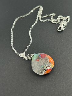 Hand made clear, blue, orange and Millefiori glass pendant on a silver plated 18 Inch chain.  This is a one of a kind beauty. Artistic Glass Jewelry Nickel-free, Artsy Silver Round Pendant Jewelry, Unique Silver Resin Jewelry, Artsy Silver Jewelry With Large Pendant, Nickel-free Multicolor Resin Jewelry, Silver Resin Pendant Jewelry, Artistic Multicolor Nickel-free Necklace, Rainbow Glass Jewelry Gift, Artistic Clear Jewelry For Gifts