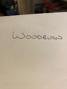 the word woodbridge written in cursive ink on a piece of white paper