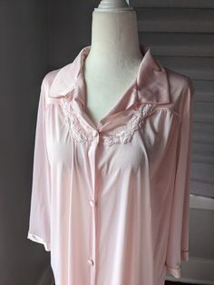 "Vintage Vanity Fair robe, could also be worn as a nightgown because it is so lightweight soft, lightweight nylon fabric with satiny finish on collar and at sleeve ends button down front with one side pocket The size tag is missing. I believe it is medium based on measurements: 22\" across front between armpits, 41\" long. I am a size 12 and tried it on. While it does fit me, robes should be loose. The mannequin is a size 6 small and it is just a tad big on it." Satin Long Sleeve Nightgown For Loungewear, Long Sleeve Satin Sleepwear For Spring, Long-sleeve Satin Nightgown For Sleepovers, Long Sleeve Satin Nightgown For Sleepovers, Satin Long Sleeve Nightgown For Sleepover, Feminine Long Sleeve Satin Sleepwear, Summer Long Sleeve Chemise For Bedtime, Feminine Long Sleeve Home Robe, Feminine Long Sleeve Robe For Home