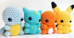 four small crocheted stuffed animals sitting next to each other