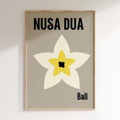 a framed poster with the words nusa dua and a yellow flower on it