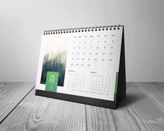 a desk calendar sitting on top of a wooden table