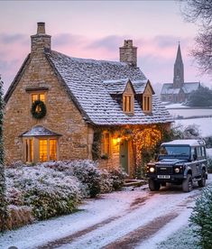 a jeep is parked in front of a house with christmas lights on it's windows