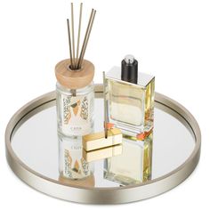 an assortment of perfumes on a glass tray