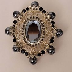 Vintage Ornate Gilded Brooch with Onyx  Has some ware. All the stones are in place. Ornate Jeweled Brooch For Formal Occasions, Silver Jeweled Brooches For Formal Occasions, Formal Silver Jeweled Brooches, Victorian Jeweled Brooches For Party, Antique Black Brooch For Wedding, Victorian Onyx Jewelry For Gifts, Antique Black Wedding Brooches, Antique Black Brooches For Evening, Antique Black Wedding Brooch