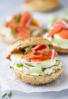 an open face sandwich with cucumber, tomato and lettuce on it