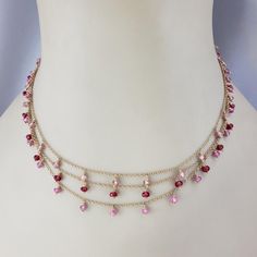 14 Karat Yellow Gold Triple Strand Gemstone Necklace-  This lovely piece features natural pink sapphires (medium pink), pink tourmaline stones (light pink) and synthetic spinel stones(dark pink) set on a 14K triple chain cable necklace.   Beads measure 6mm each.  Stamped: 14K  Size: 15 inches  Weight:  6.2 dwt. / 9.7 gr.  Very good condition, professionally polished.  Will come packaged in a gift box or pouch (when possible) and will be shipped U.S. Priority Mail Insured.  JAGI ID 1/31/24 Flat Gold Necklace, Light Weight Necklace, Chanel Pendant, Peridot Necklace, Necklace Beads, Pink Set, Tourmaline Stone, Medallion Necklace, Sapphire Necklace