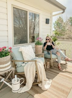 a woman sitting on top of a wooden chair