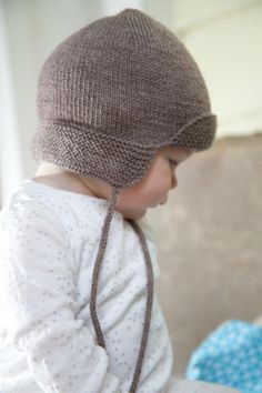 a small child wearing a knitted hat