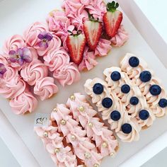 there are three different types of pastries on the trays with strawberries and blueberries