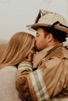 a firefighter kissing his girlfriend on the cheek