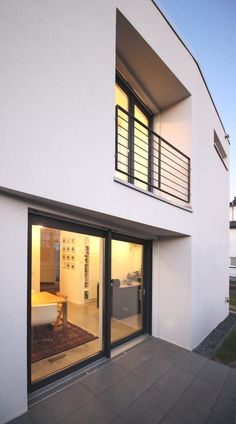 an outside view of a modern house with sliding glass doors