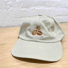 Discover the perfect blend of style and comfort with our Pigment-Dyed Garment Washed Coffee Bean Hat in the color 'stone'. Crafted to complement any casual ensemble, this hat features a relaxed fit, thanks to its one-size-fits-all design. Whether you're grabbing your morning brew or heading out for a leisurely stroll, its laid-back charm effortlessly matches your vibe. The front of the hat showcases three embroidered coffee beans. Meanwhile, the back features the distinctive "Generous Coffee Co" Adjustable Casual Baseball Cap, Casual Cotton Sun Hat With Short Brim, Trendy Cotton Hats With Flat Brim, Trendy Cotton Flat Brim Hats, Spring Hats With Adjustable Fit For Everyday, Casual Sun Hat With Adjustable Fit And Curved Brim, Adjustable Fit Hats For Everyday Spring Wear, Adjustable Cotton Hats For Everyday, Casual Sun Hat With Curved Brim And Adjustable Fit