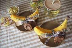 two brown plates topped with bananas sitting on top of a checkered tablecloth covered table