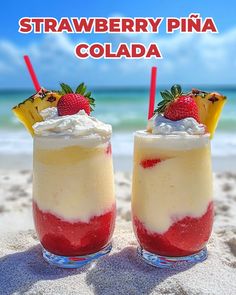 two glasses filled with ice cream and strawberries on the beach