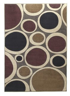 a rug with circles on it in brown, black and tan colors is shown here