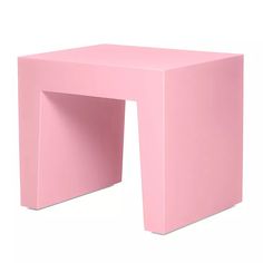 a small pink table sitting on top of a white floor