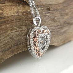 "Sterling Silver Celtic Dancing Stone & Heart Pendant with CZs Rose Gold Plate Celtic Knot with CZ Trim Shimmering Dancing Stone Center 1\" long x 3/4\" wide including bale Adjustable Sterling Silver chain 18\" or 20\" Chain and Pendant 6.3 grams; pendant only 3.2 grams In Stock! Ships Immediately. Celtic Damhsa CZ Pendant Damhsa is Dancing in Gaelic Pronunciation of the word \"Damhsa\" is \"Dow-sa\" Made in Ireland by Boru Ships Free within the USA 21 Day Returns Items must be returned in n Heart Cut Locket Necklace For Wedding, Wedding Heart Cut Locket Necklace, Heart Cut Locket Necklace For Mother's Day Anniversary, Heart Cut Locket Necklace For Anniversary And Mother's Day, White Gold Locket Necklace With Heart Cut For Gift, Anniversary Jewelry With Cubic Zirconia Box Chain, White Gold Heart Cut Locket Necklace Gift, Cubic Zirconia Box Chain Necklace As Gift, Cubic Zirconia Box Chain Necklace For Gift