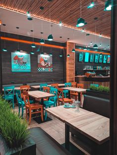 the interior of a restaurant with wooden tables and chairs