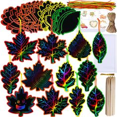 an assortment of leaf shapes are shown on a white background with other items in the background