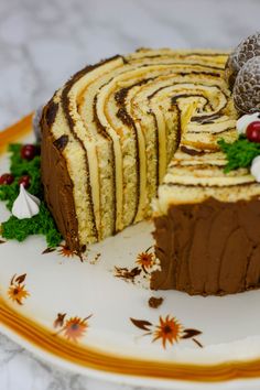 there is a cake that has been cut into pieces and served on a plate with other food items