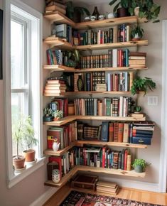 a bookshelf filled with lots of books next to a window in a room