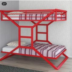 a red bunk bed sitting next to a wall with a striped pillow on top of it