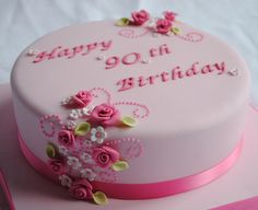 a birthday cake with pink frosting and flowers