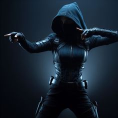 a woman dressed in black is pointing her finger at the camera while wearing a hoodie