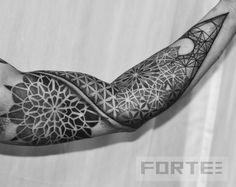 a man's arm with an intricate tattoo design on it