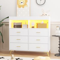 a baby's room with a white crib and yellow lights on the drawers